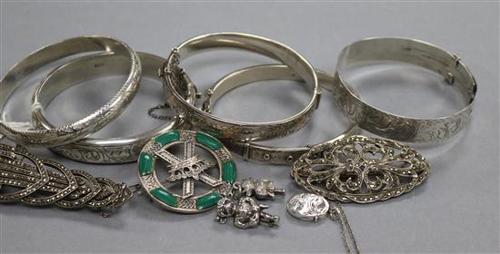 Five assorted silver bangles, three brooches including marcasite, a locket, a hardstone pendant necklace and two demon charms.